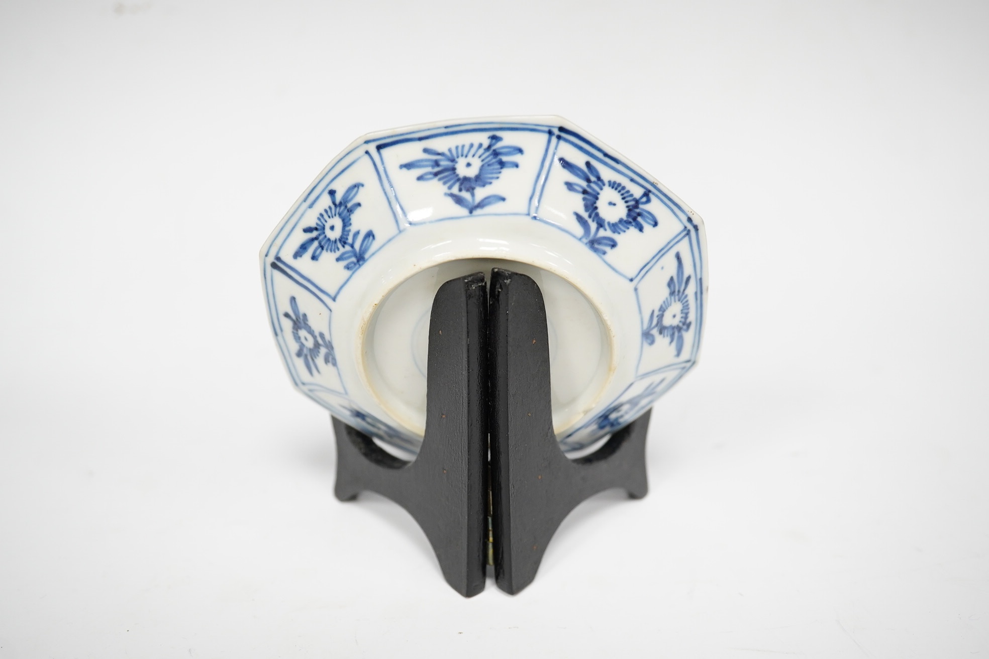 A Chinese blue and white octagonal saucer dish, Kangxi period, with stand, 9.5cm in diameter. Condition - good